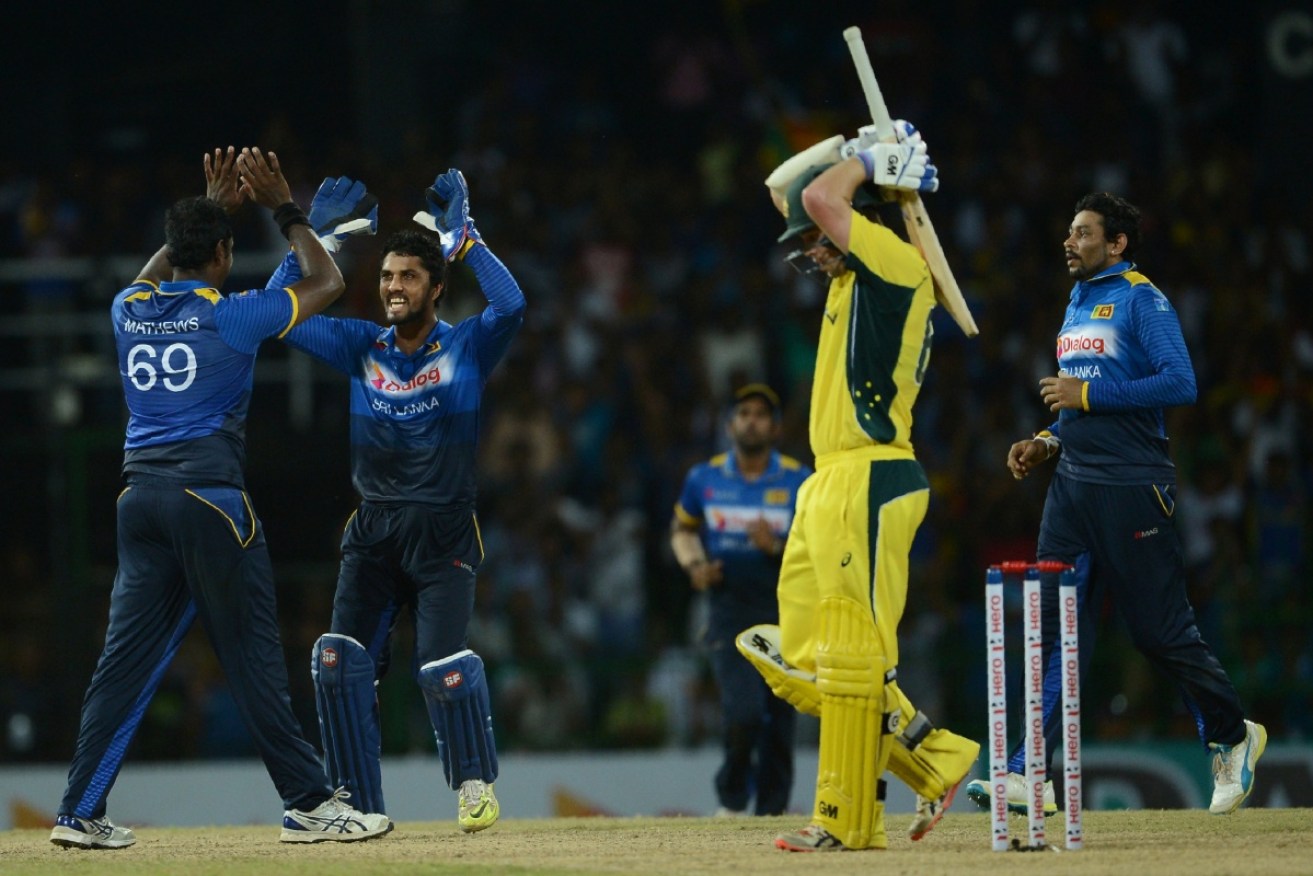 Sri Lanka's Angelo Mathews  (left) celebrates after dismissing Travis Head in the second ODI