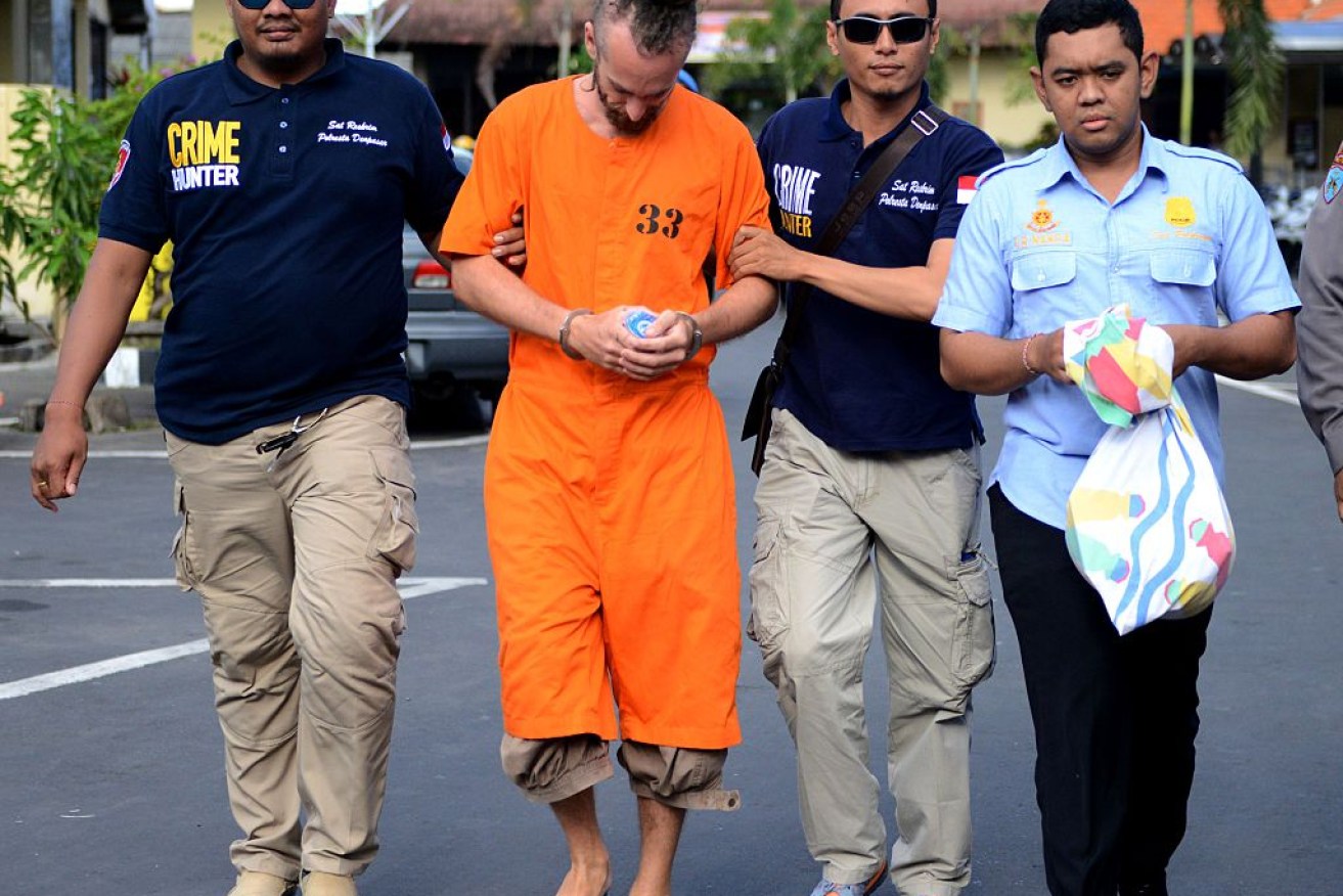 Detained British national David Taylor (2nd L) escorted by Indonesian police.