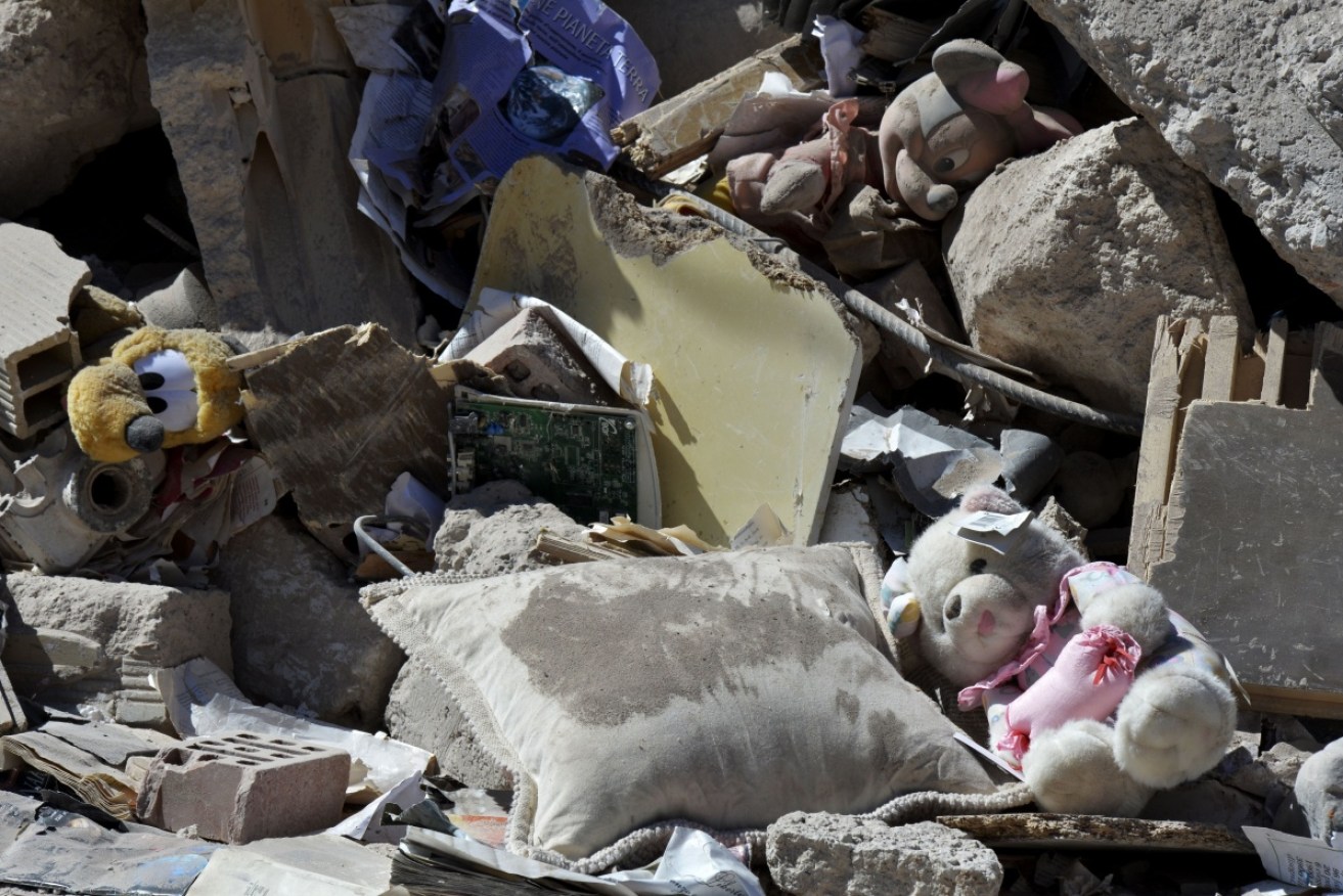 Children's toys lay among rubble and debris in Amatrice, four days after the 6.2 magnitude earthquake hit the region.