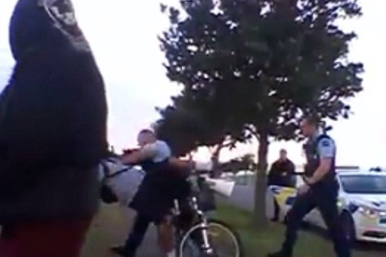 New Zealand boy, 13, thrown from his bike by policeman.