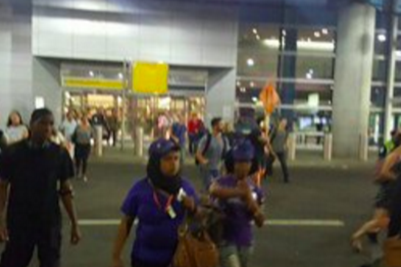 Scenes outside the airport as people are evacuated.