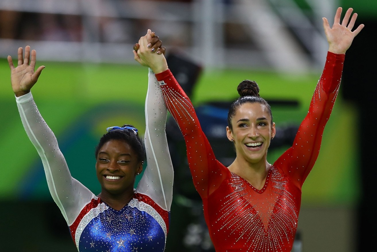 Biles and Raisman wave to the crowd after their final.