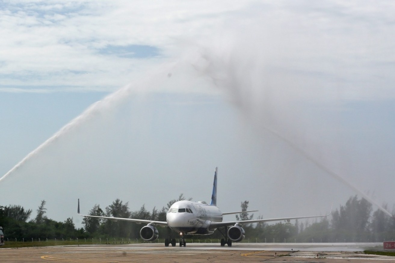 The first regularly scheduled flight to Cuba lands at the Abel Santamaria airport.