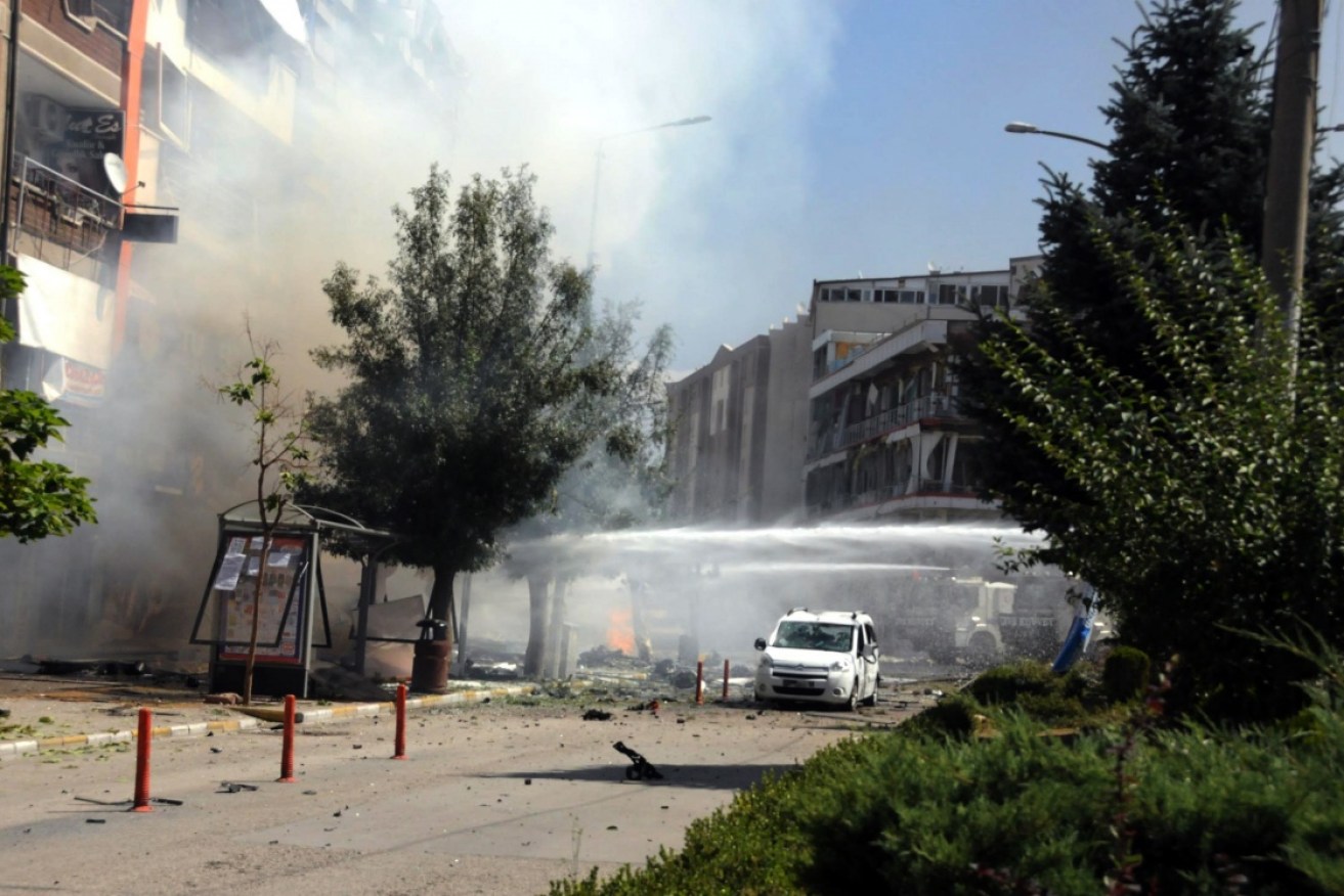 Firefighters work to extinguish a fire after a car bomb attack in the city center of Van, eastern Turkey.