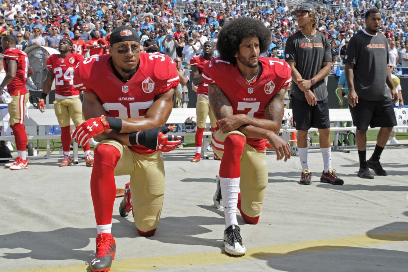 San Francisco's Colin Kaepernick and Eric Reid kneel during the national anthem before an NFL game.