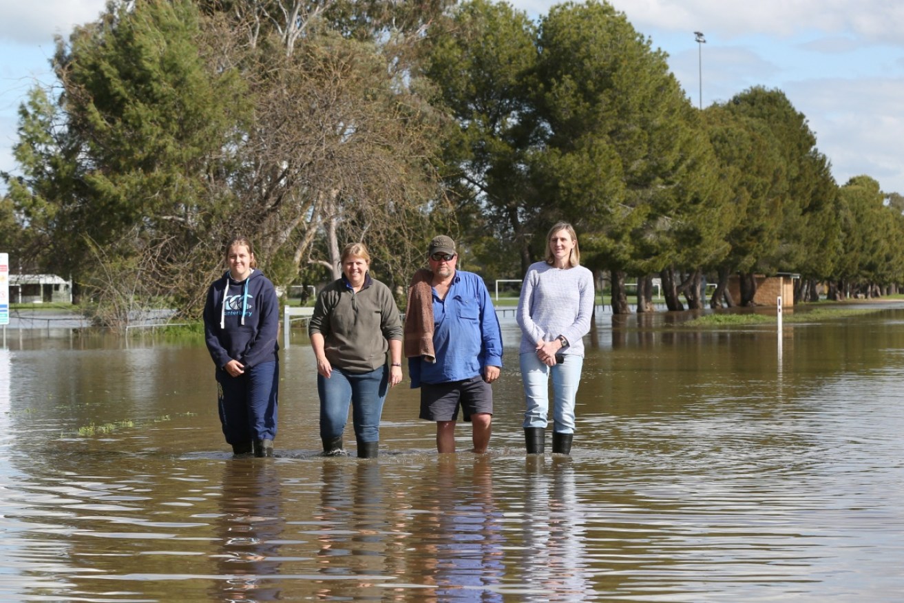 Forbes locals pose amid the deluge. 