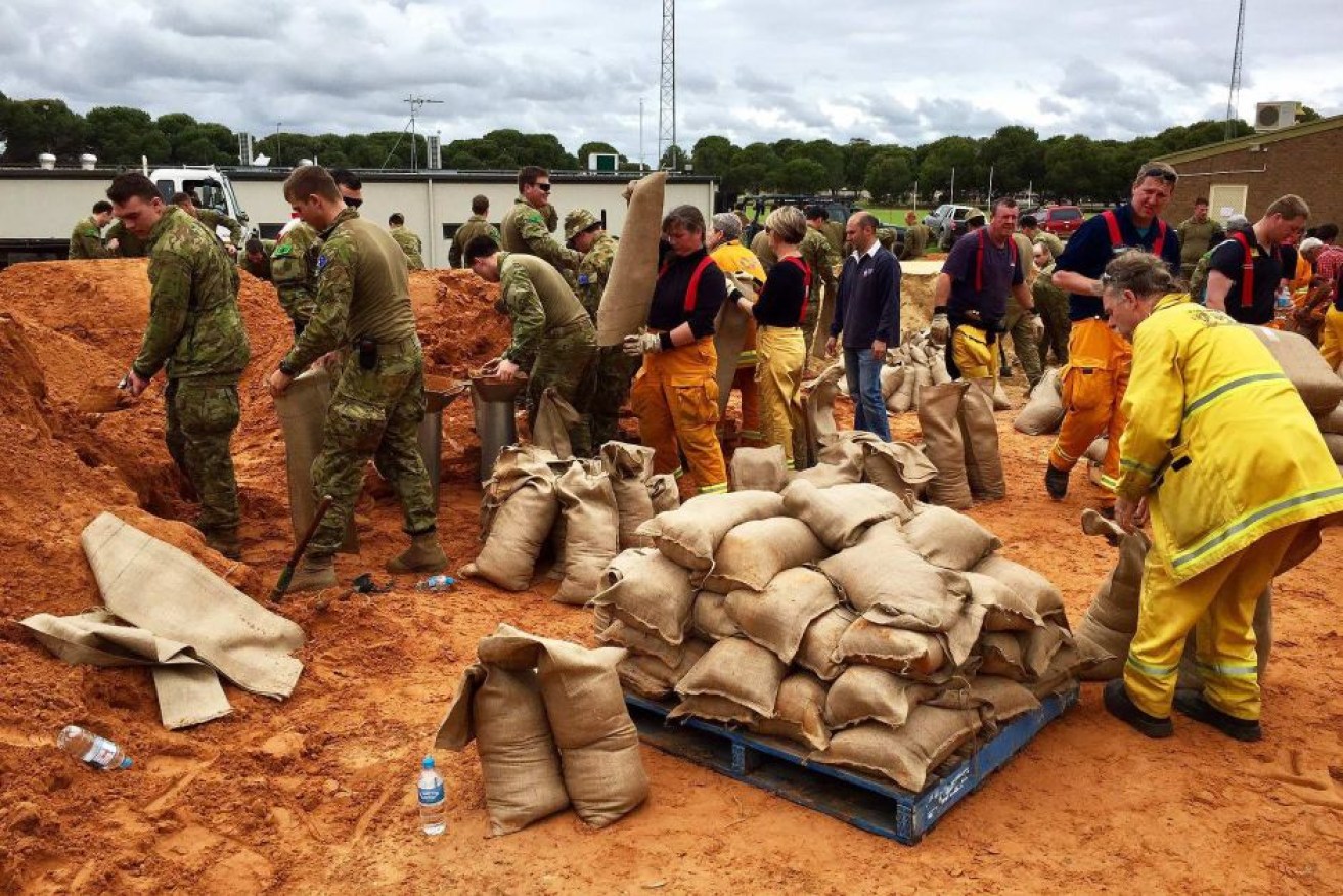 Defence Force personnel lend a hand with sandbagging ahead of peak flooding in Adelaide's north.