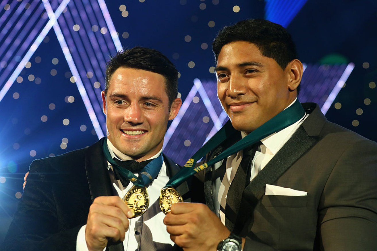 Storm star Cooper Cronk and Cowboys' Jason Taumalolo pose with their medals. 