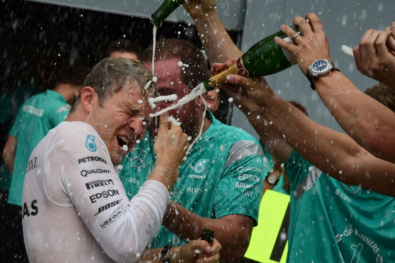 Mercedes Formula 1 driver Nico Rosberg celebrates his Italian GP win in the pit