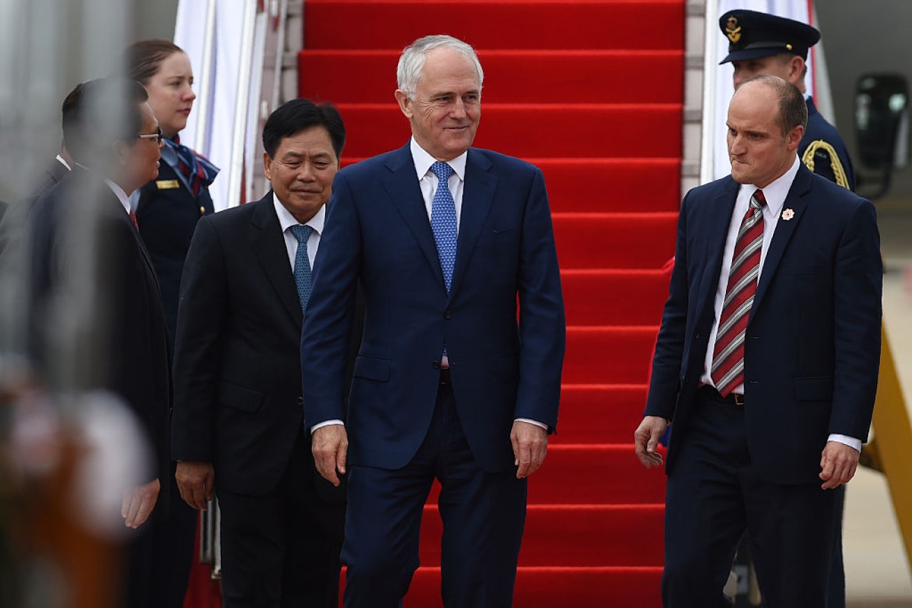 Prime Minister Malcolm Turnbull (C) arrives in Vientiane, Laos.