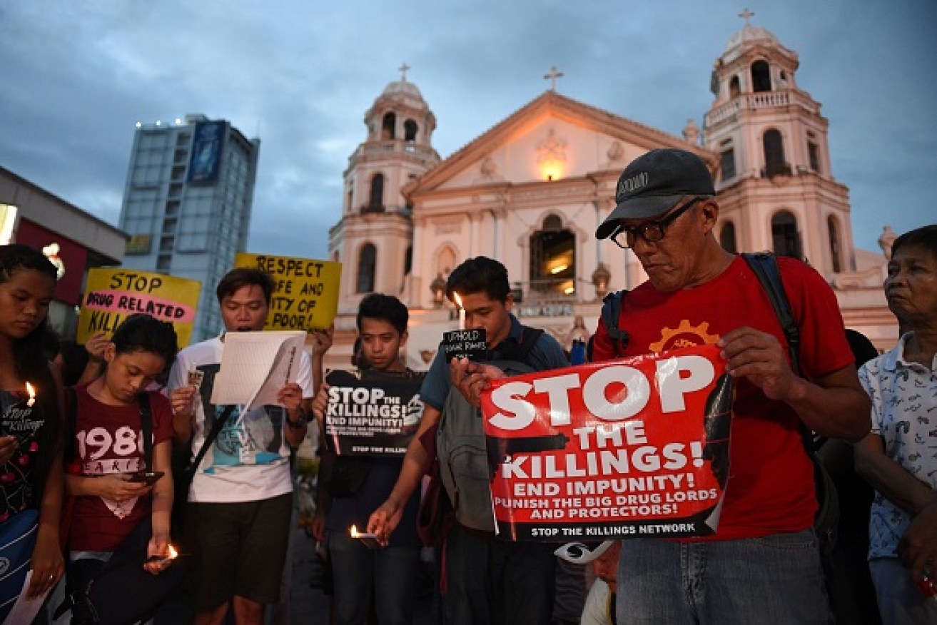 Activists hold a candlelight vigil last September for victims of drug killings. Photo: Getty