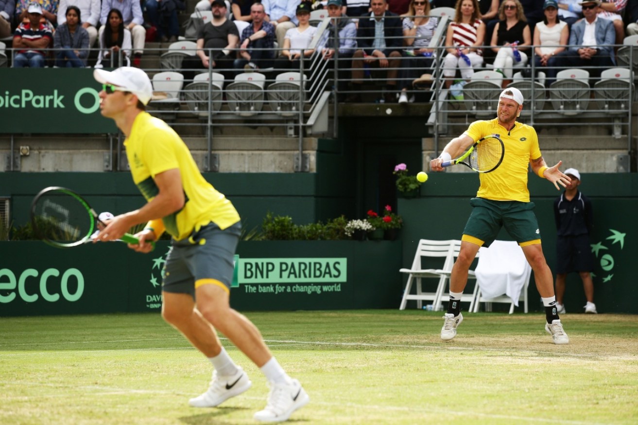 Australia has retained its Davis Cup World Group spot after winning Saturday's doubles.