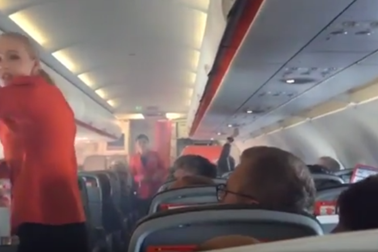 Cabin crew rushed around the aircraft as smoke billowed into it. 