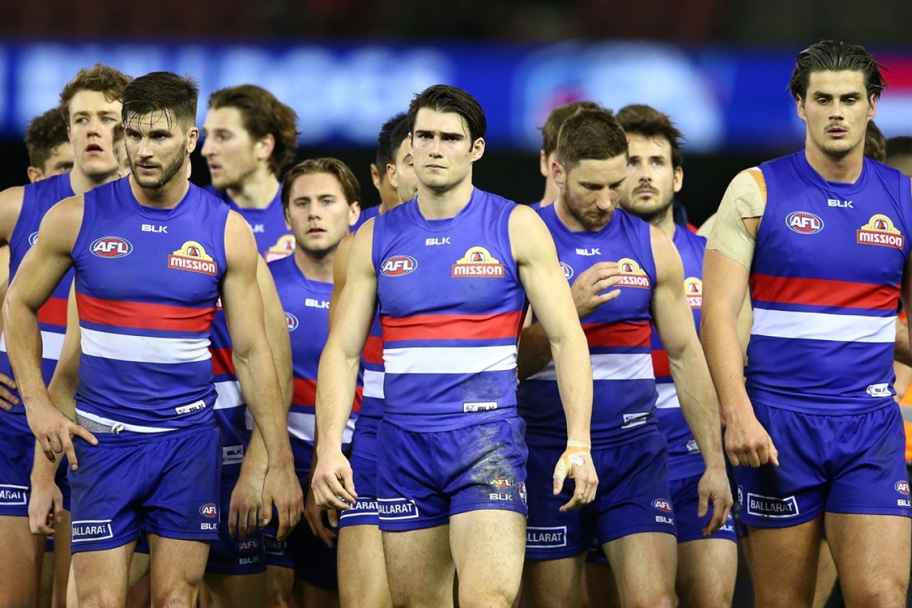 The dejected Dogs leave Etihad Stadium after a loss.