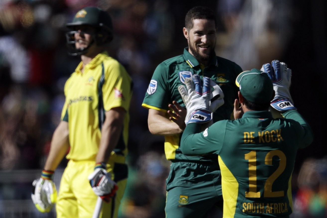 South Africa's bowler Wayne Parnell celebrates with teammate Quinton de Kock, after dismissing Mitchell Marsh for 19.