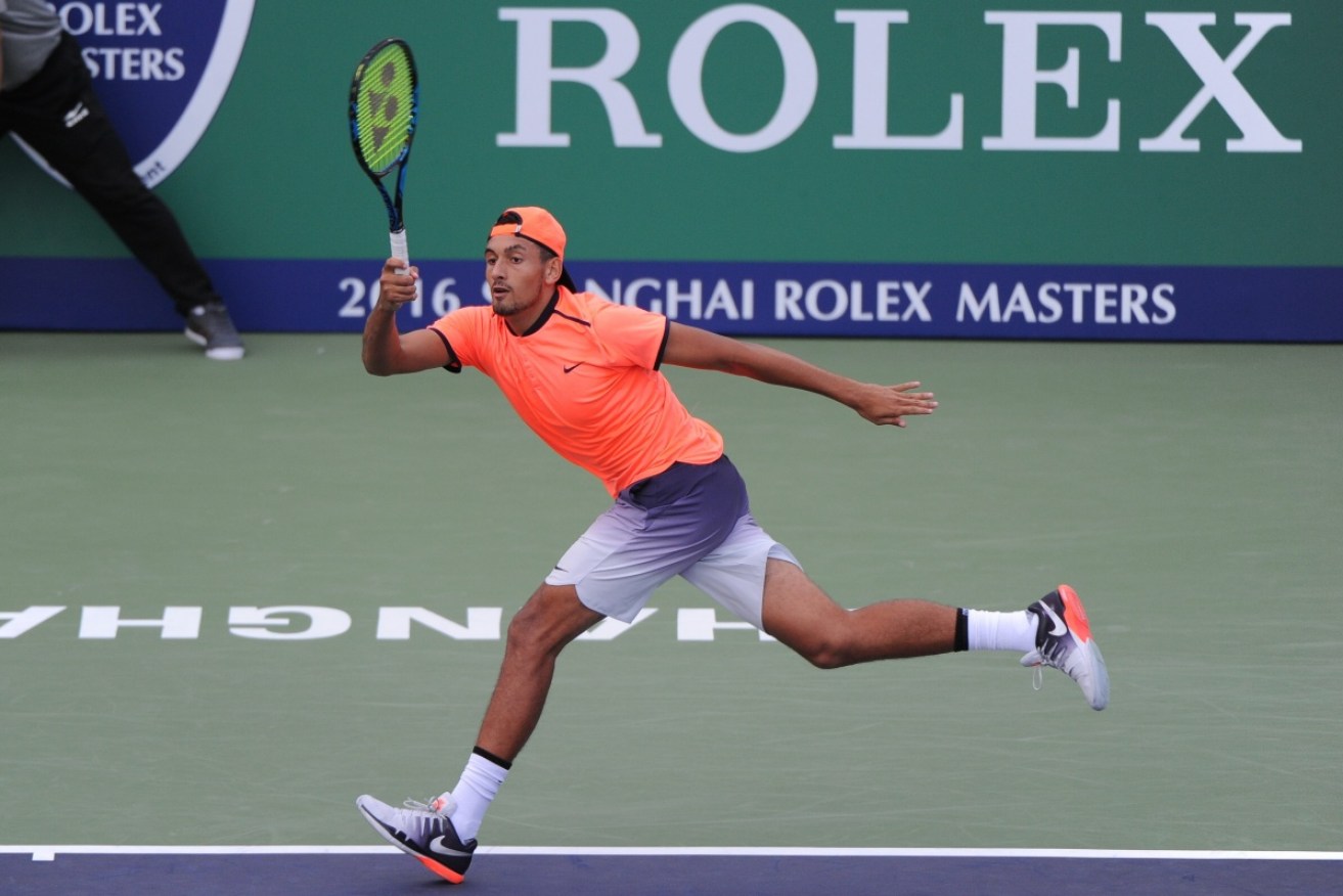 Nick Kyrgios returns a shot to Sam Querrey during his first–up win. 