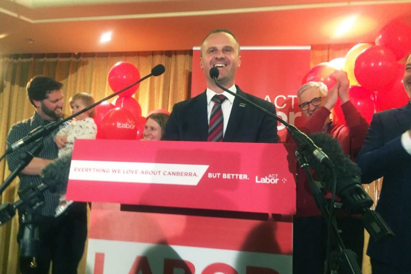 Andrew Barr, flanked by his family, claims victory after the ACT election.