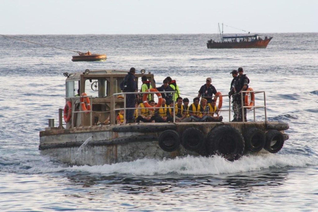 Rescued asylum seekers arrive on Christmas Island in 2012. 