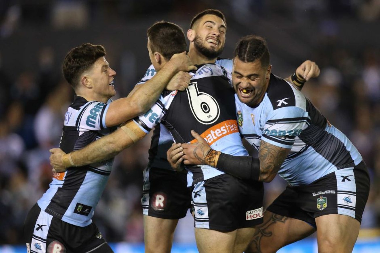 Andrew Fifita (right) hugs James Maloney (centre, #6) during the season.