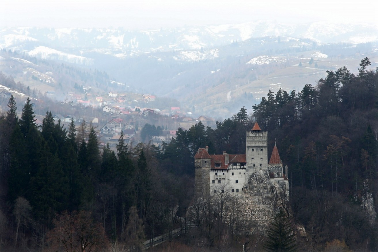 Bran Castle stands among Transylvanian mountains in Romania.
