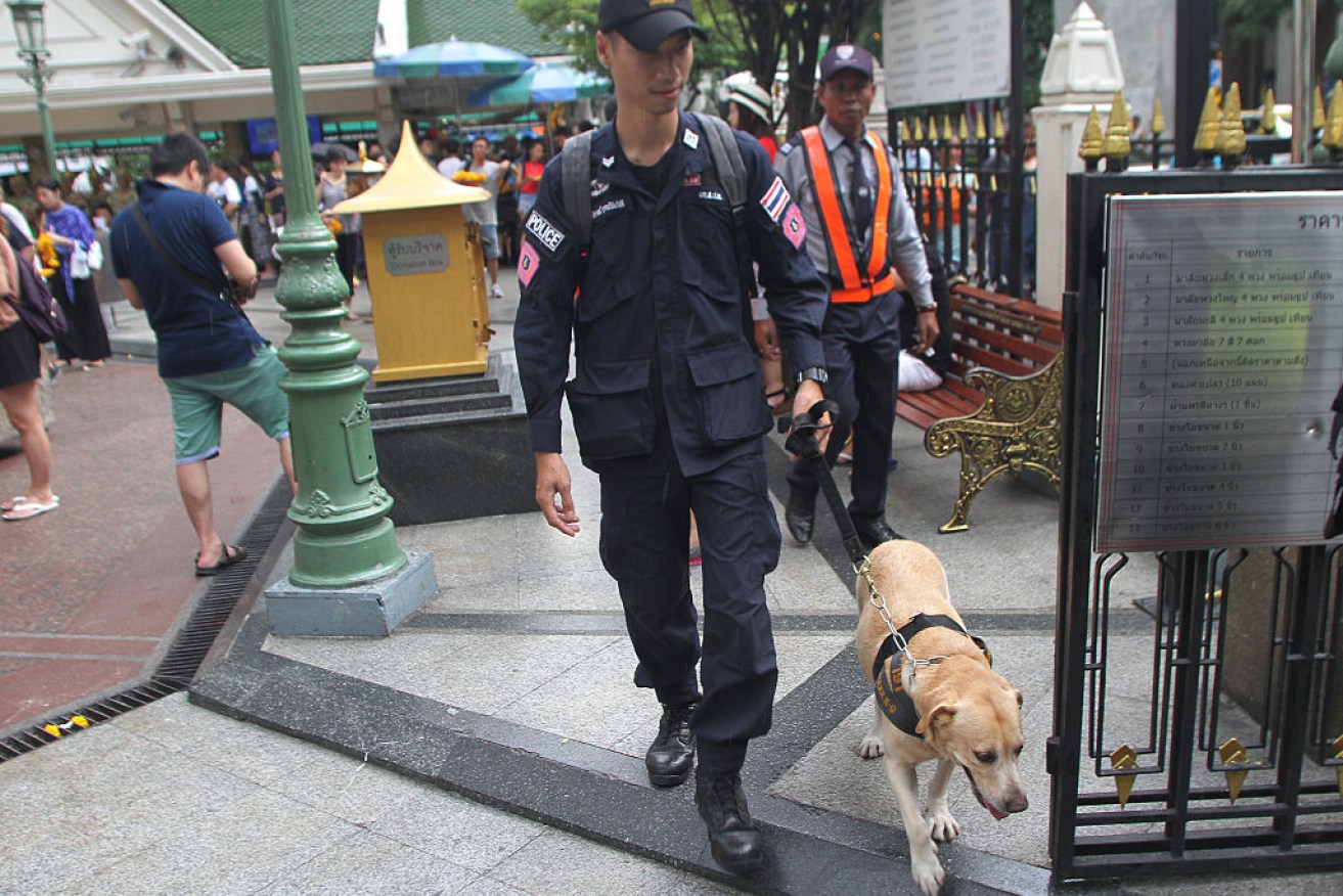 A Thai police officer patrols at Erawan Shrine in Bangkok in August to build confidence among tourists after several explosions in the southern Thailand. 