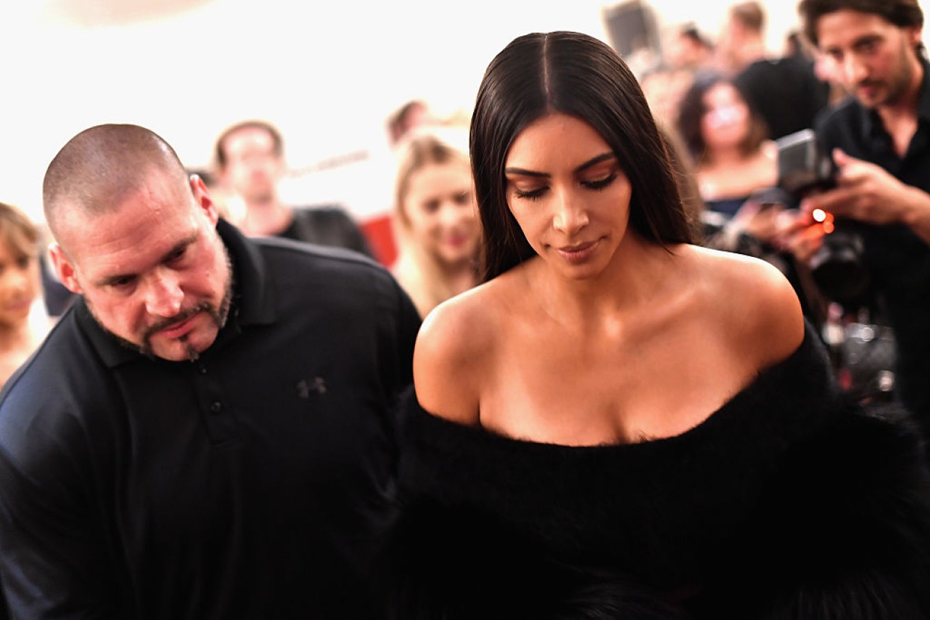 Kardashian with one of her security guards during Paris Fashion Week. 