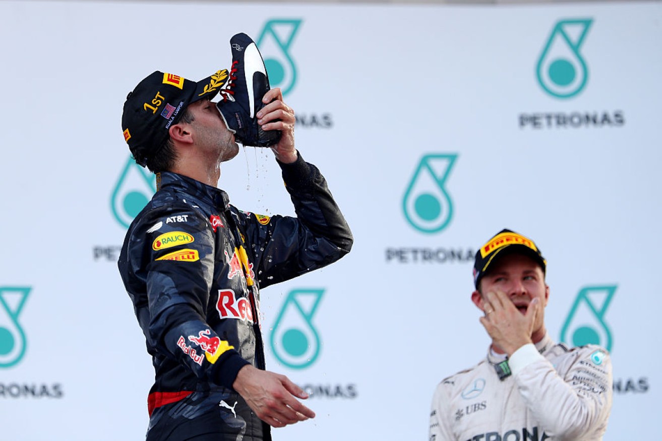Daniel Ricciardo celebrates with a 'shoey' after winning the Malaysia Formula One Grand Prix.