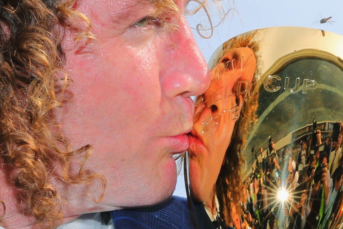 Trainer Ciaron Maher celebrates with the Caulfield Cup.