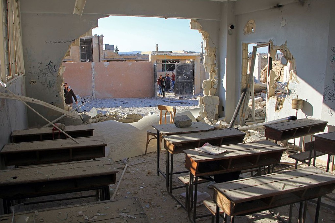 A damaged classroom at a school after it was hit in an air strike in the village of Hass.