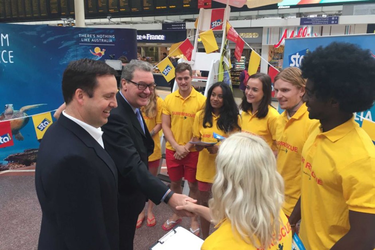 Alexander Downer (right) and Steve Ciobo meet with lifesaver-look-alikes at Victoria Station.