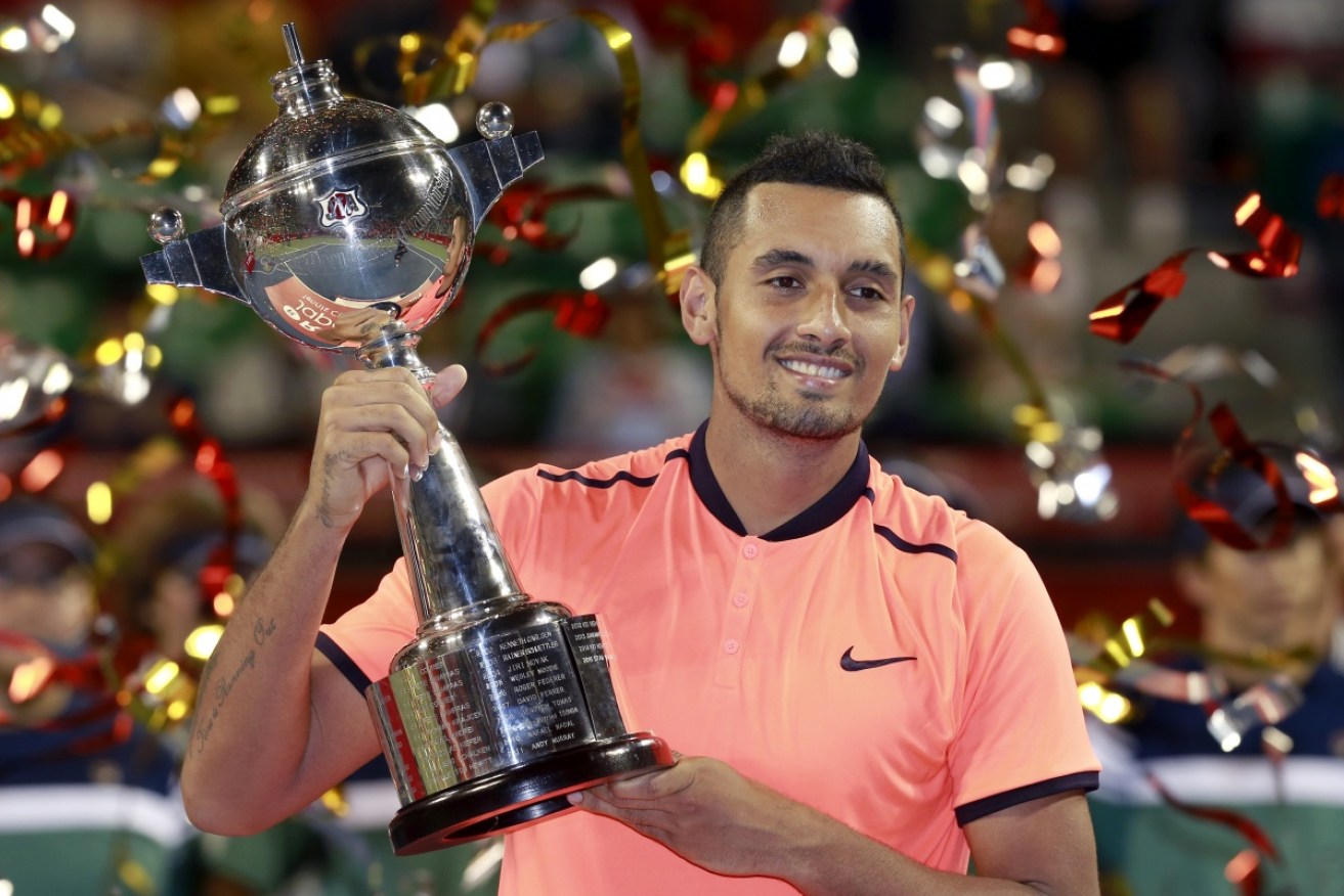 Nick Kyrgios lifts the Japan Open trophy earlier this week. It was his third career title. Photo: AAP