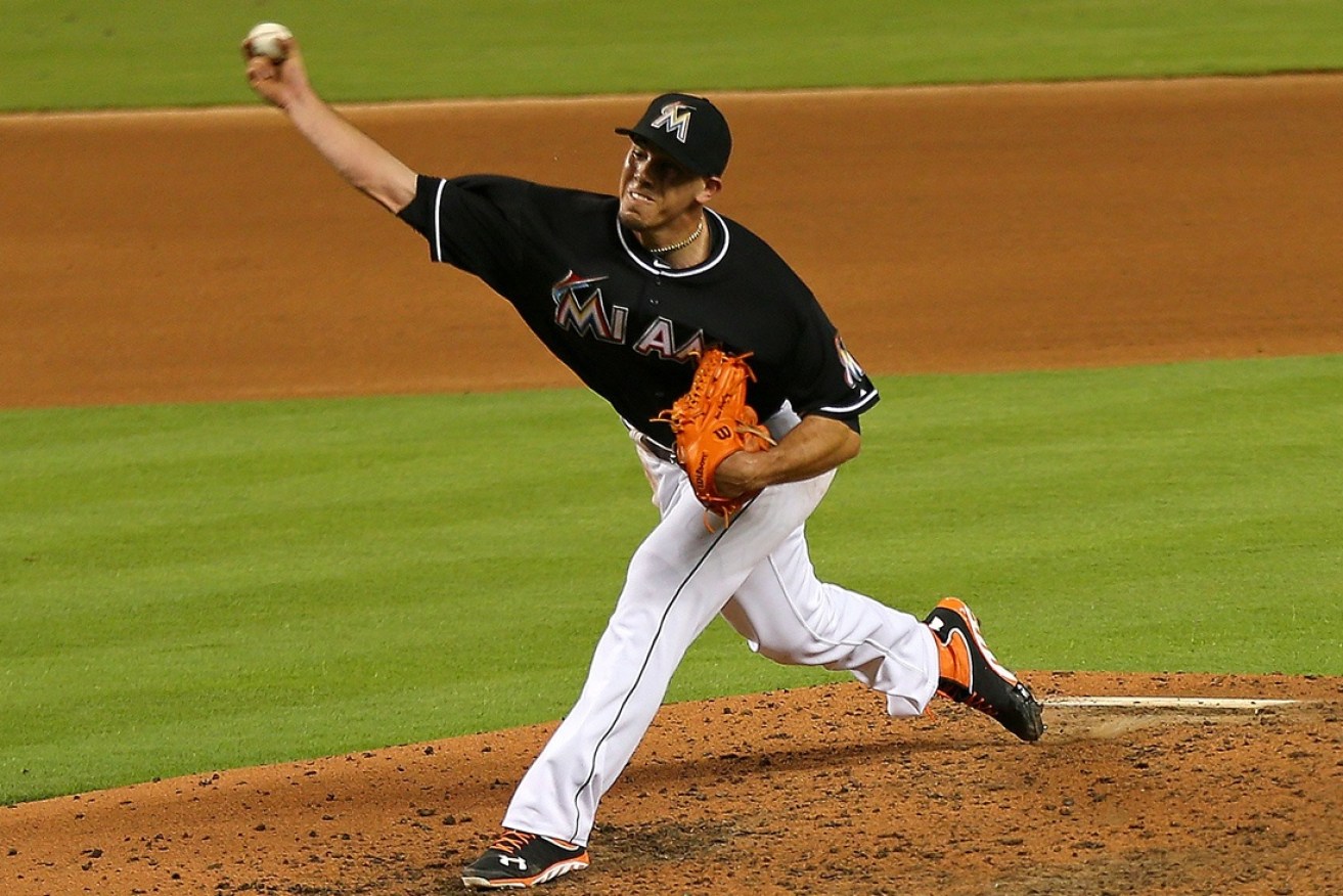 Fernandez pitching for Miami.