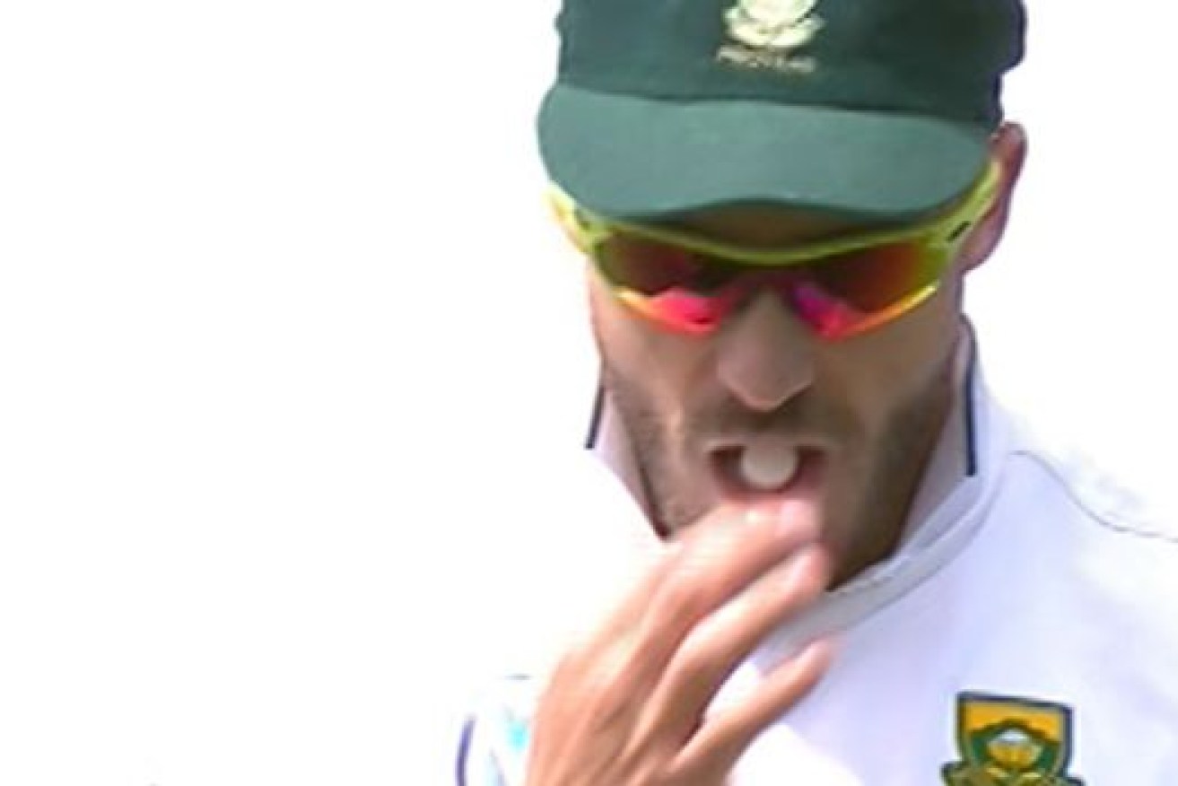 South African captain Faf du Pleases prepares to poiish the ball, with a mint clearly seen on his tongue.