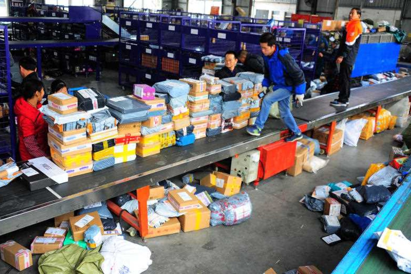 Chinese workers sort out parcels at a distribution centre in Taicang city.
