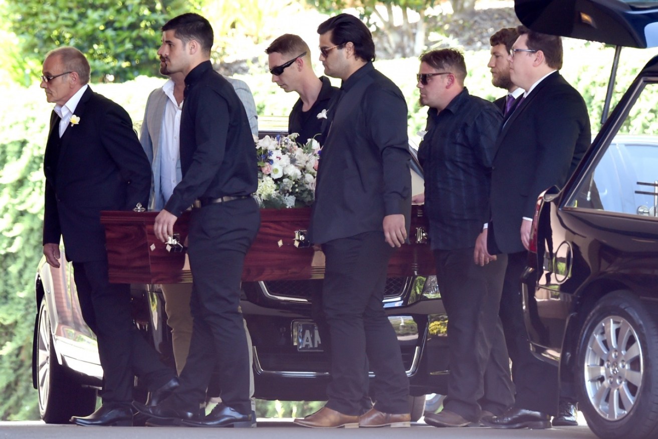Pallbearers carry the casket of Cindy Low at the Palmdale Hillside Chapel on the Central Coast.