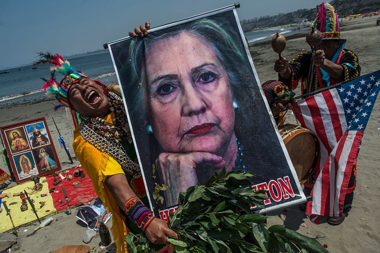 Shamans perform a ritual of predictions for the upcoming US election with posters of presidential candidates Donald Trump and Hilary Clinton at the Agua Dulce beach in Lima, Peru.