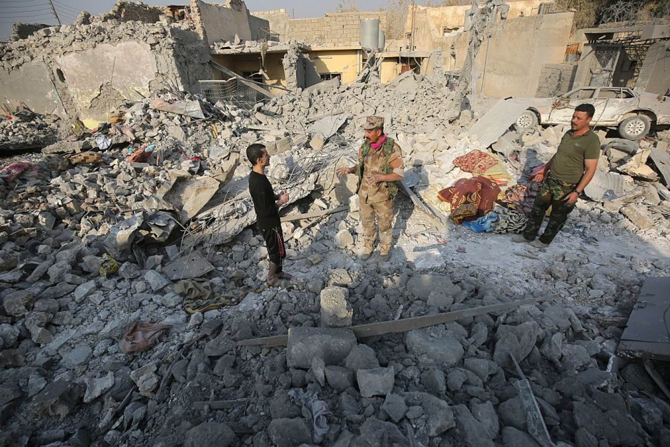 Iraqis inspect the damage at a site in the Hamam al-Alil area, about 30km south of Mosul.