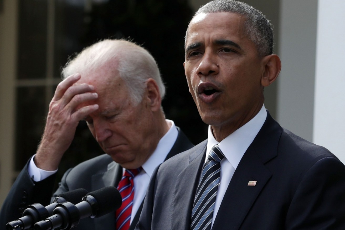 Barack Obama speaking at the White House as Vice–President Joe Biden looks on. 