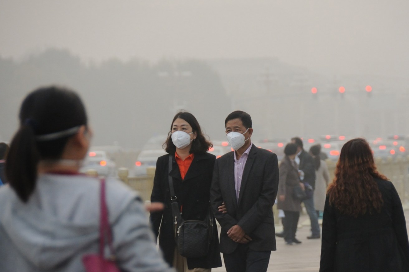 Citizens wear masks to stop inhaling the pollution in Beijing, one of the world's worst spots for toxic emissions.