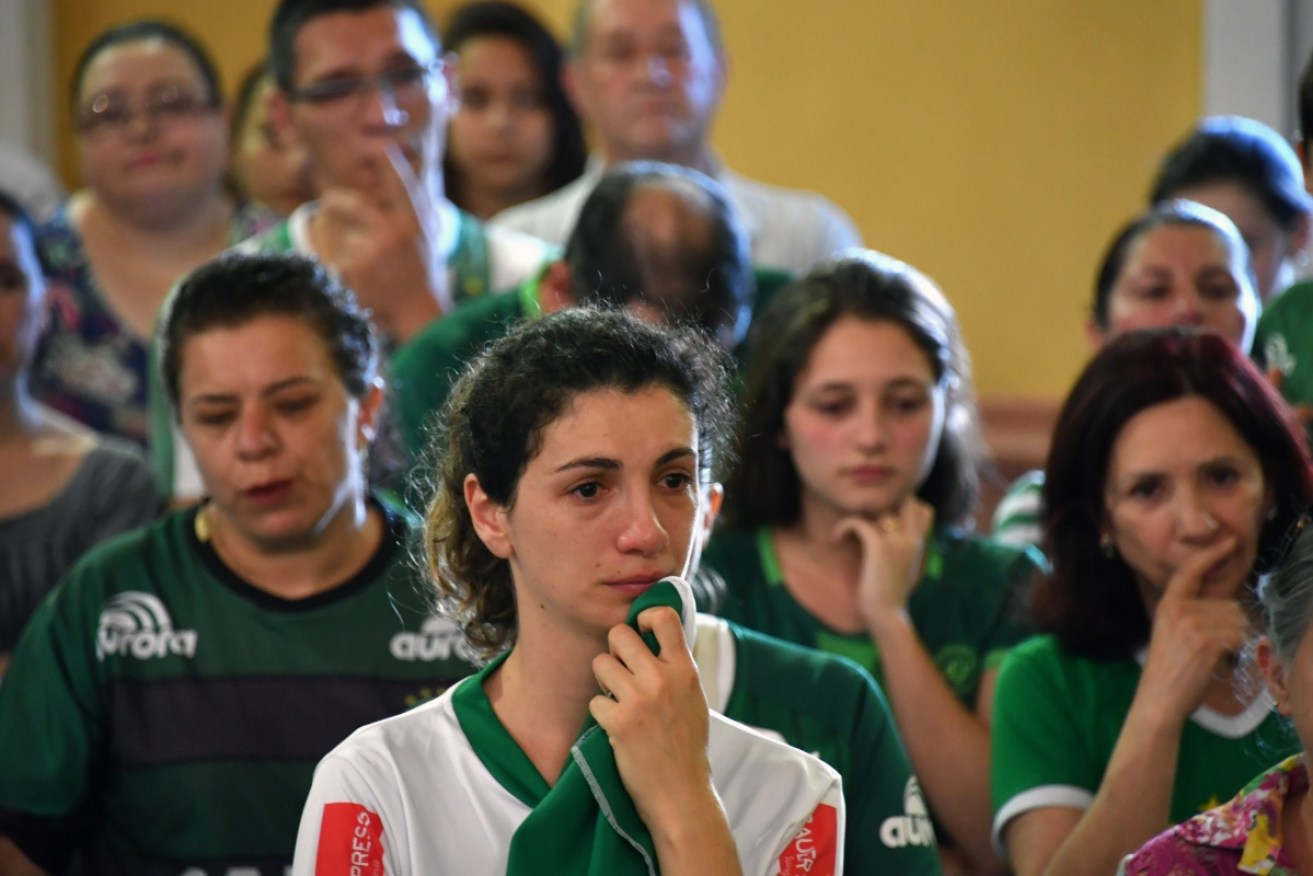 Distraught Chapecoense fans attend a mass in memoriam of their players and staff who perished. 