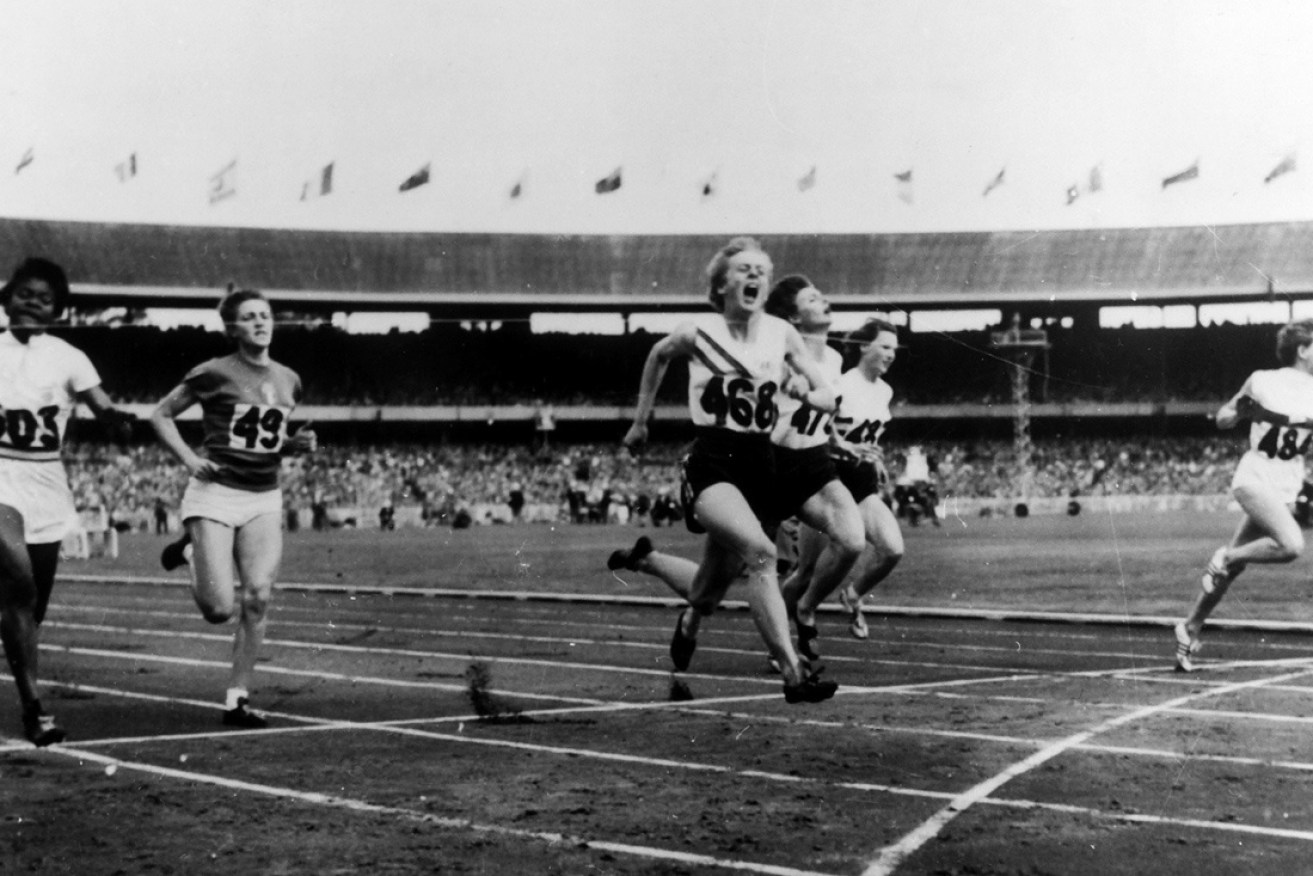 Betty Cuthbert crosses the line first in the 1956 Olympic Games 100m sprint.