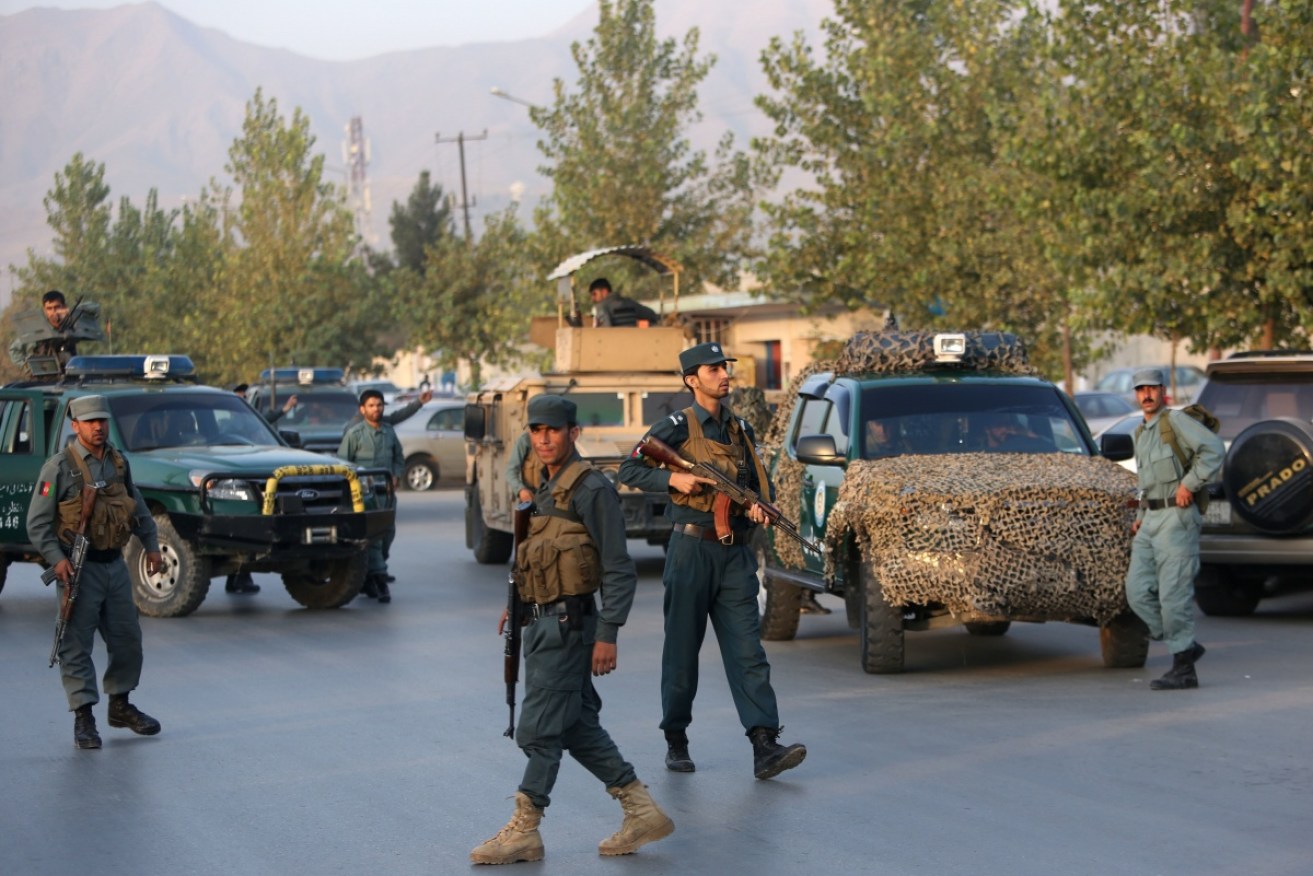 Afghan security forces stand guard on the streets of Kabul.