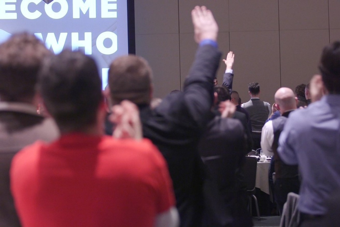 A conference attendee gives the Nazi salute. 