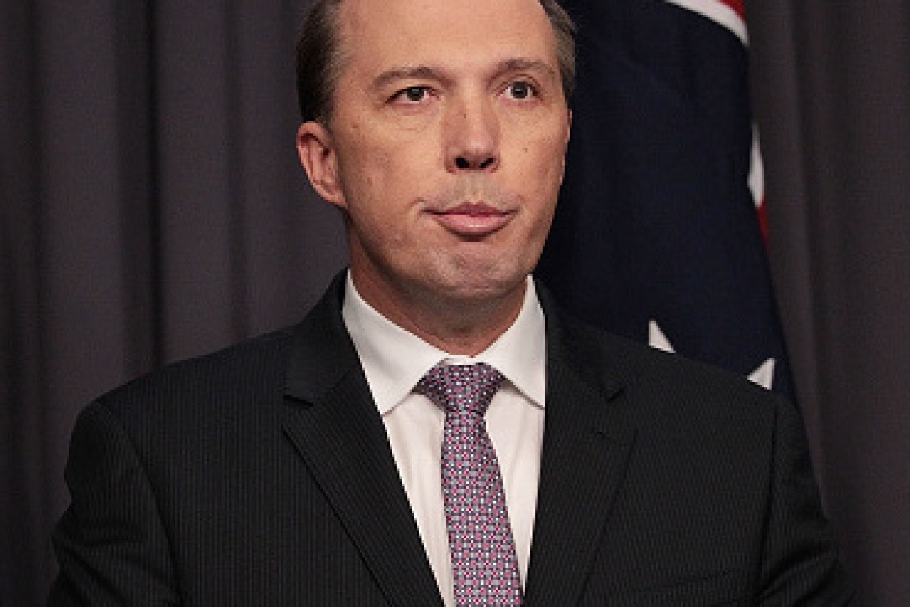 Immigration Minister Peter Dutton is pictured at a press conference