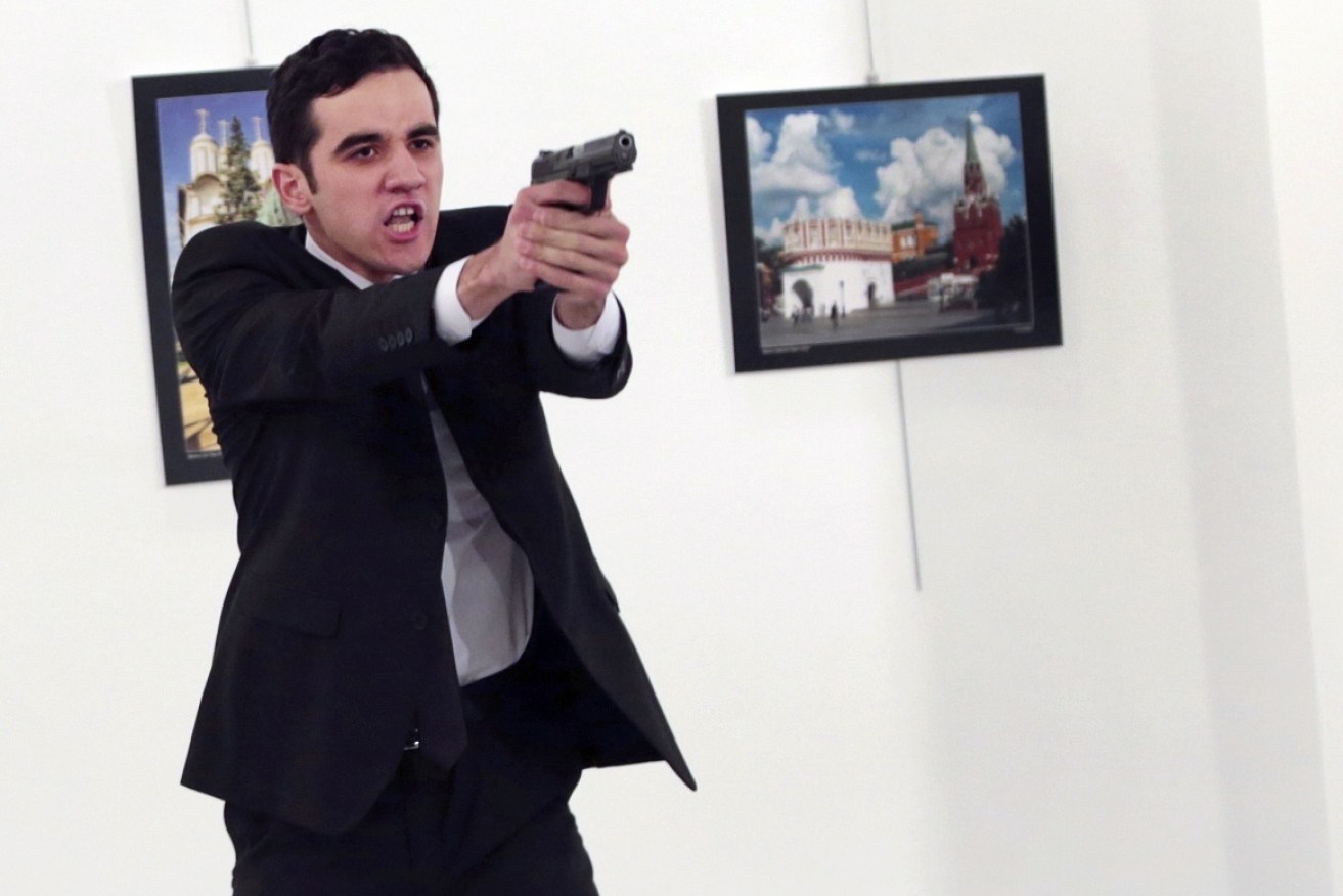 The photographer at the scene of a Russian ambassador's assassination has recounted the chaotic event.