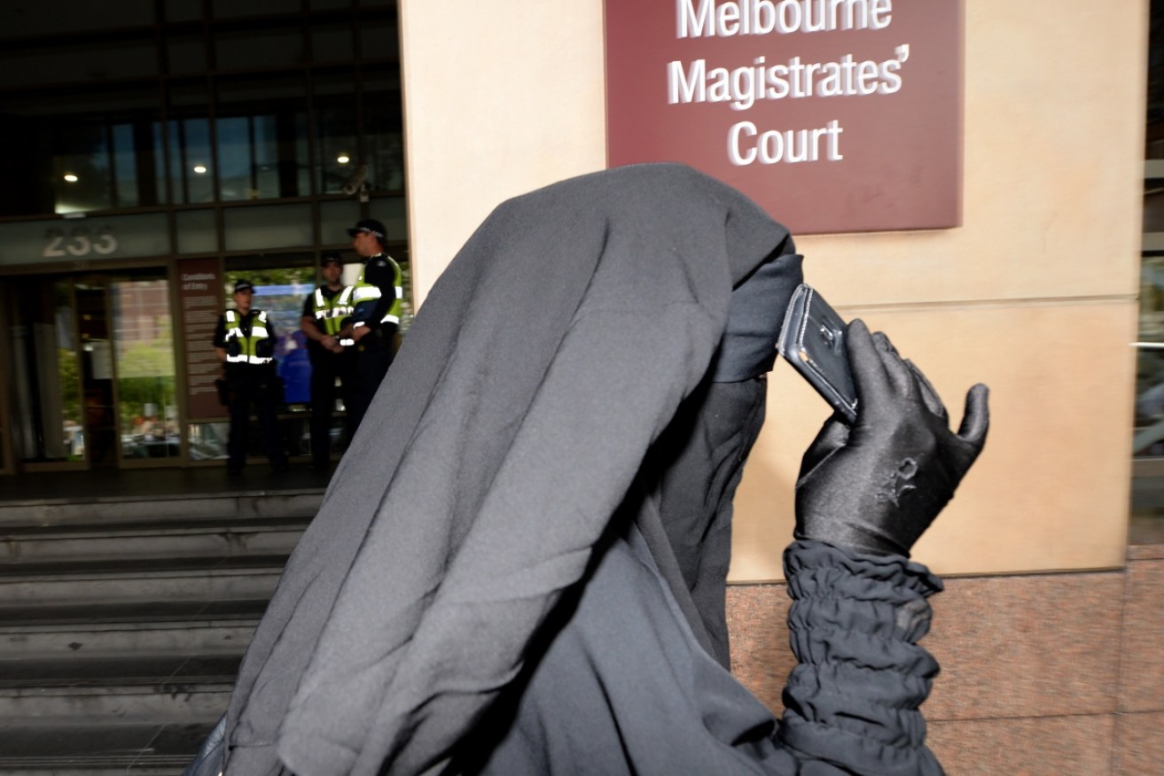 A family member leaves the Melbourne court precinct.