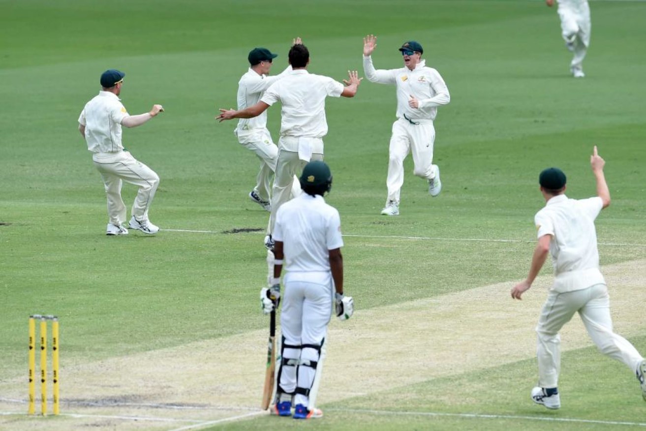 Agony and ecstasy... Australia celebrates its nail-biting win over Pakistan at the Gabba.