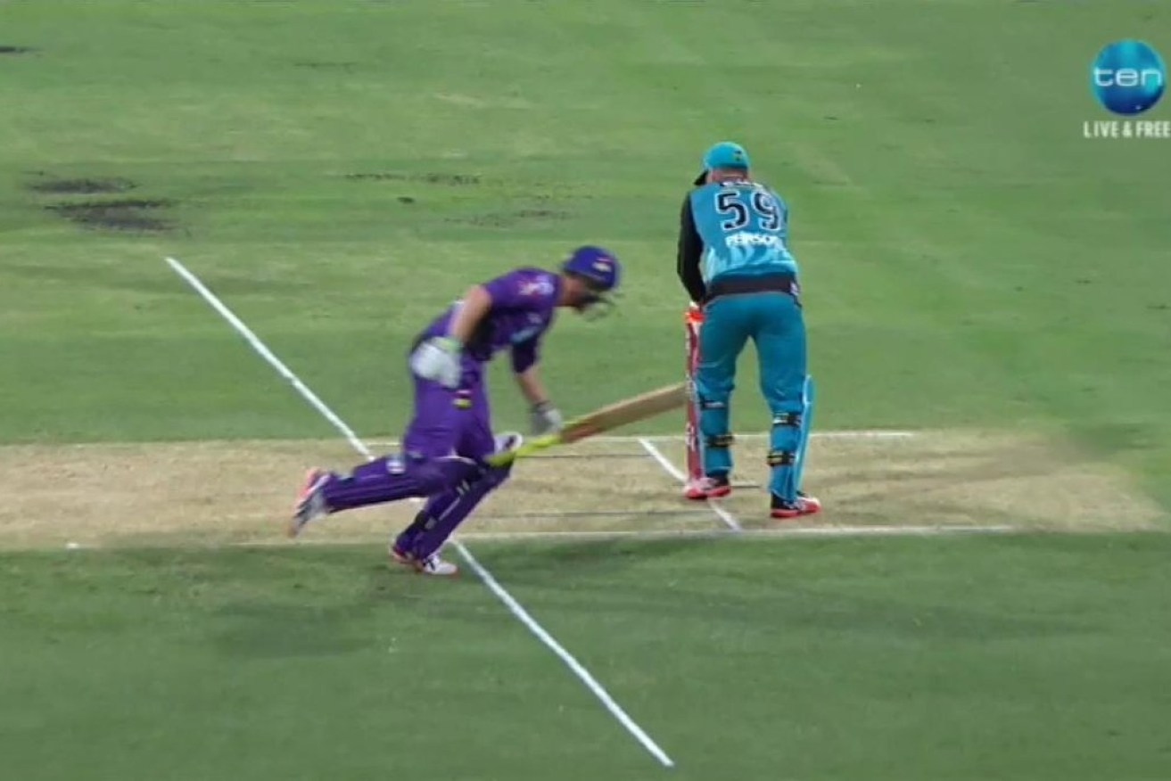 Hobart's George Bailey is caught short of his ground as the flashing bails light up.