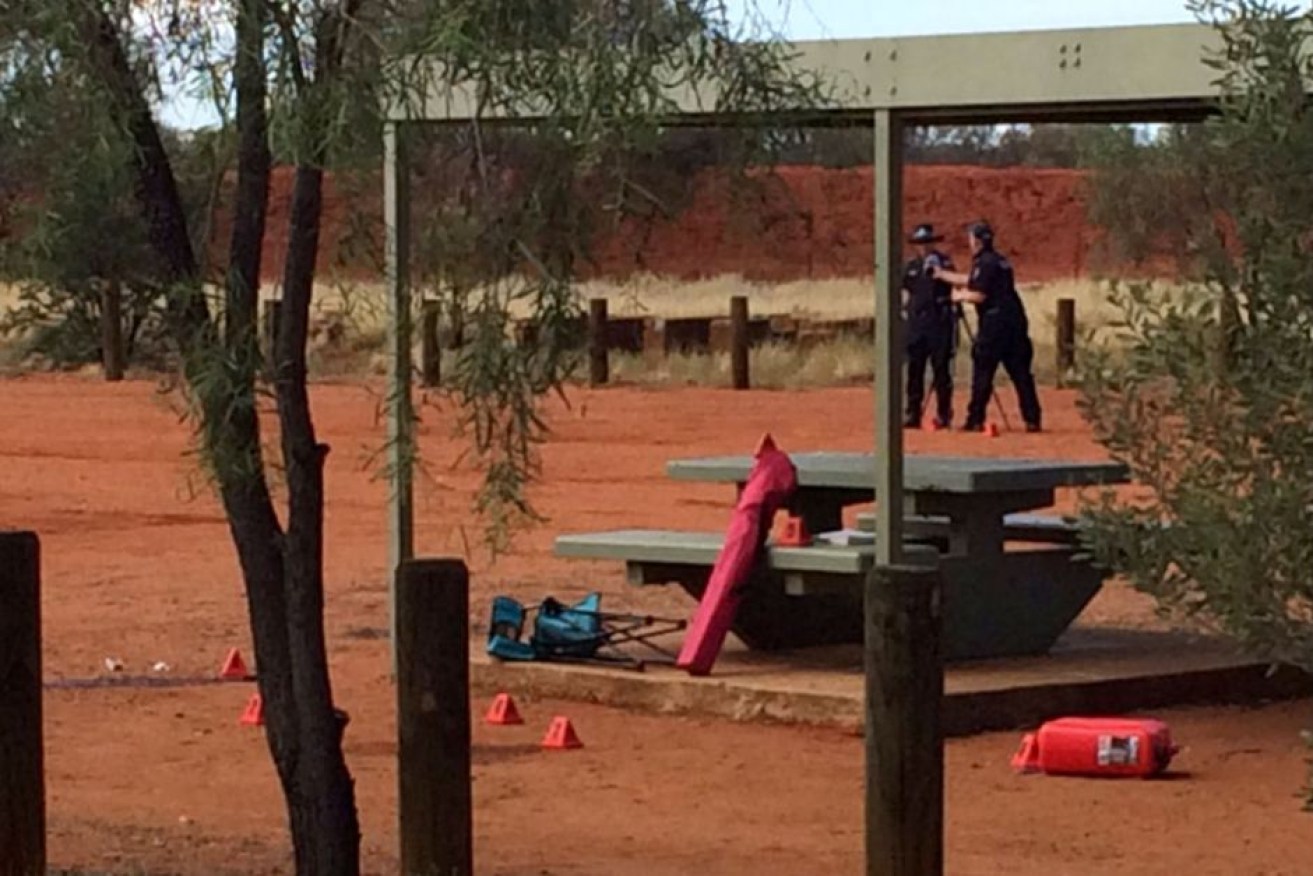 NT Police at a crime scene at Connor Well roadside stop where a French tourist has been killed.