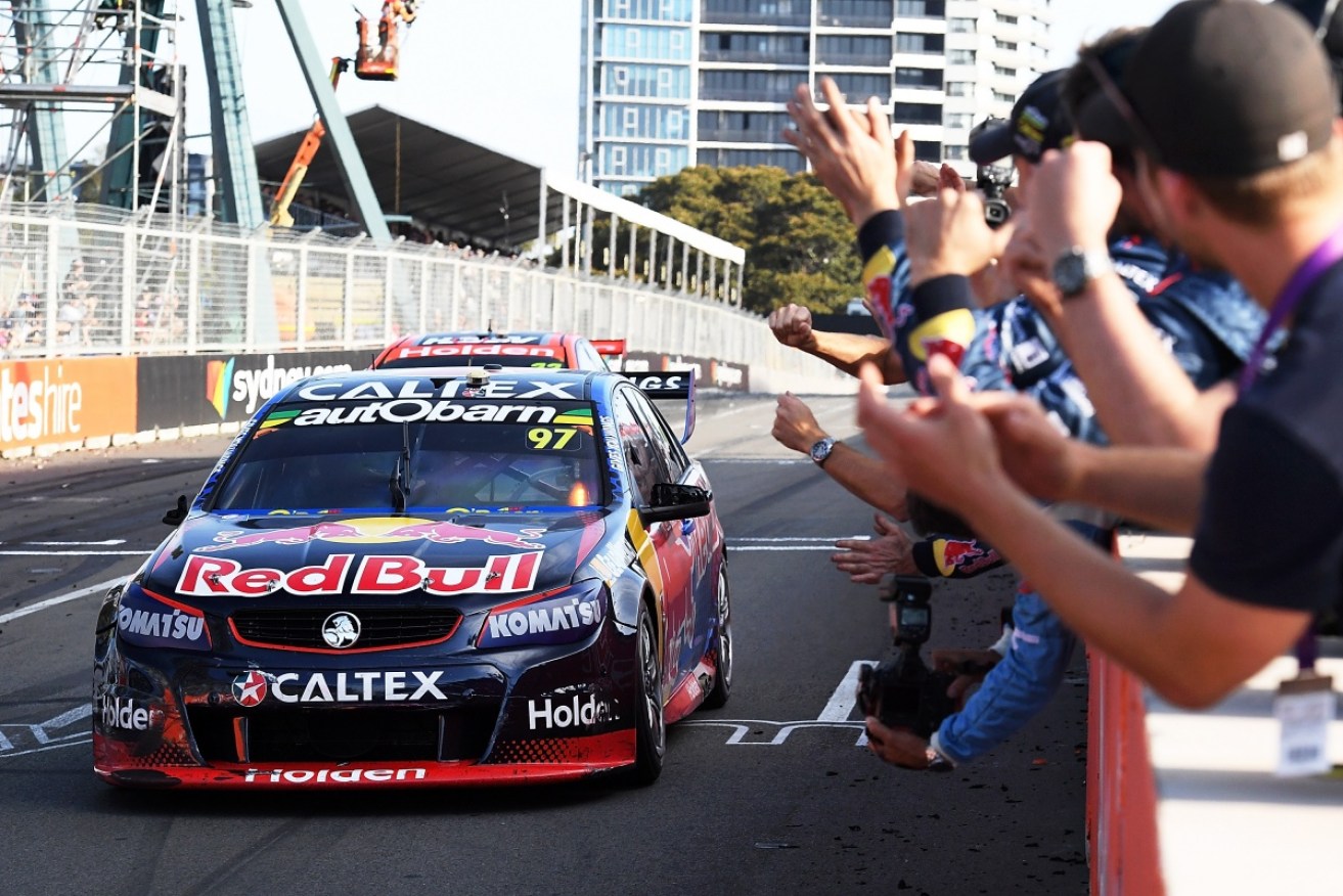 Shane Van Gisbergen crosses the finish line  in third place to stitch up the Supercars drivers championship.